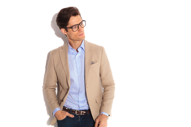 man wearing glasses while posing with hand in pocket - Fotó, kép