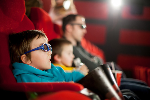 Father and two children, boys, watching cartoon movie in the cinema on 3D - Foto, Imagem