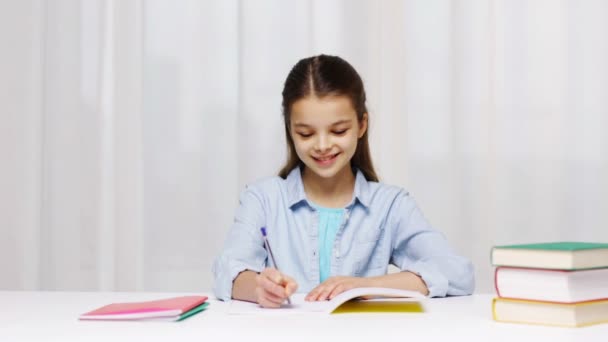 school girl hand writing math task to notepad - Video, Çekim