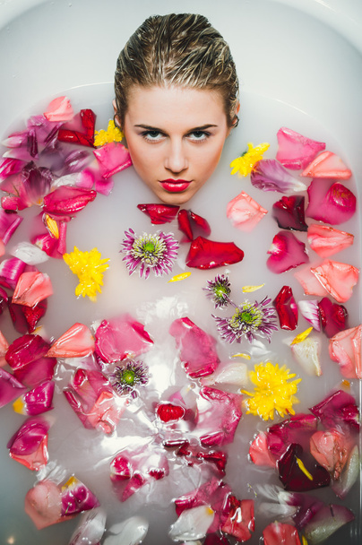 Glamour woman with silk skin having bath in rose petals - Фото, изображение