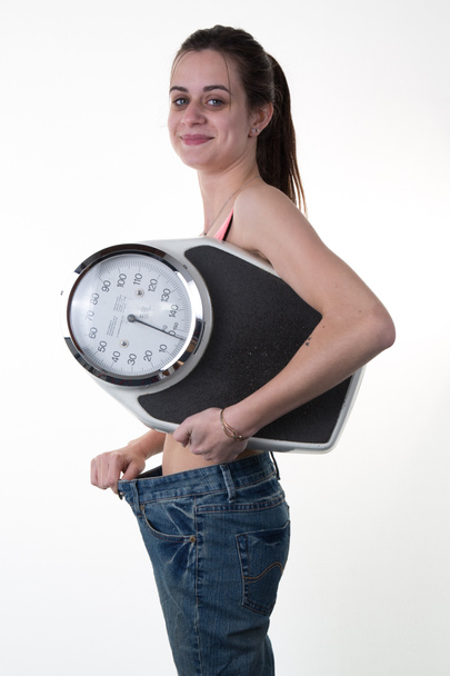 Portrait of a weight loss female holding a weight scale isolated on white background - Photo, Image