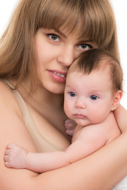 Portrait of beautiful smiling young mother with a baby - Foto, afbeelding