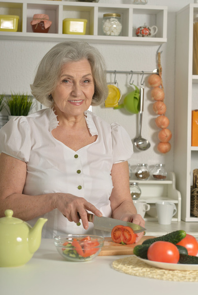 Senior woman cooking in kitchen - Foto, imagen