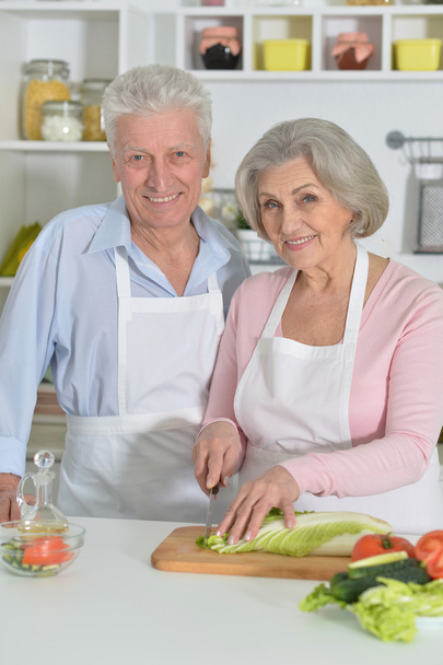 senior man and woman  in the kitchen - Фото, изображение