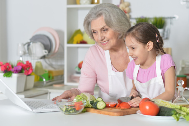 Senior woman with granddaughter cooking - Photo, image