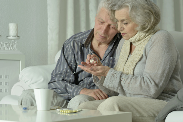 sick Elderly  couple  with pills - 写真・画像