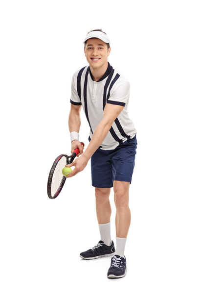Young tennis player preparing for a serve  - Valokuva, kuva