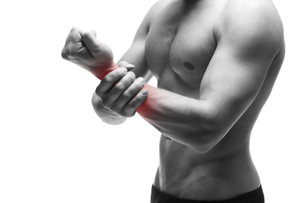 Pain in the hand. Muscular male body. Handsome bodybuilder posing in studio. Isolated on white background with red dot - Foto, immagini