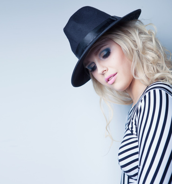 Young attractive blonde woman wearing hat and stripy top - Photo, Image