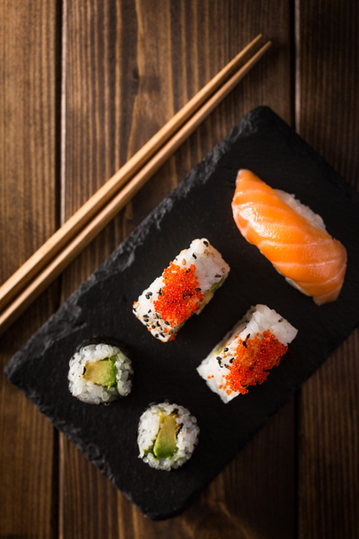 Maki sushi on a wooden table. Top view - Foto, imagen