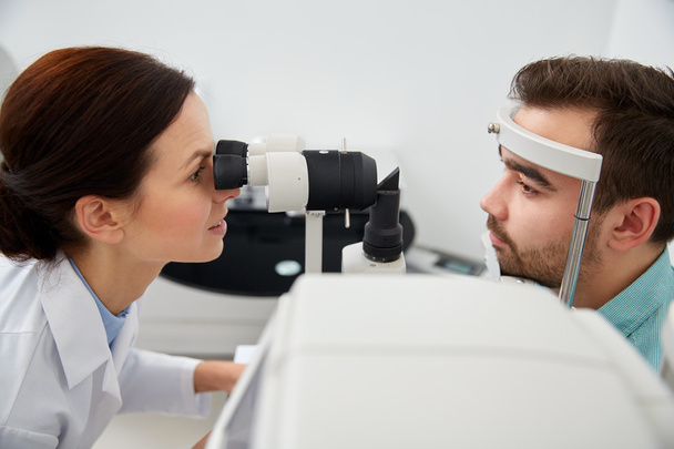 optician with tonometer and patient at eye clinic - Valokuva, kuva