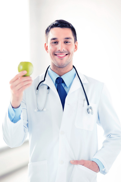 male doctor with green apple - Фото, изображение