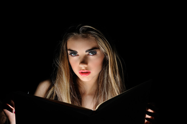 Portrait of young sexy woman reading a magic book - Foto, Imagem