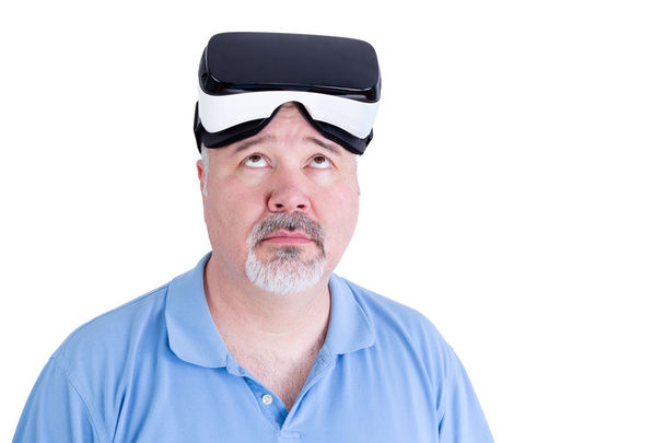 Adult male with virtual reality glasses looks up - Photo, image