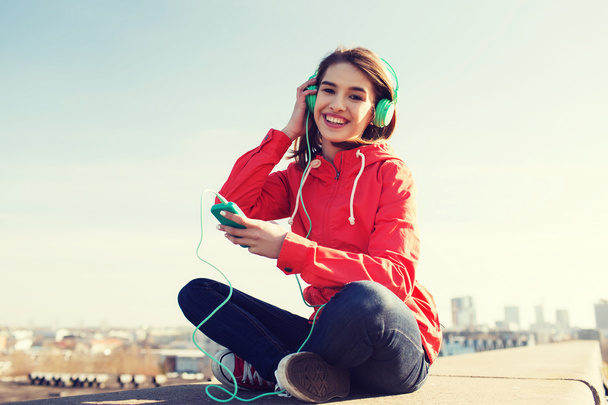 happy young woman with smartphone and headphones - Photo, Image