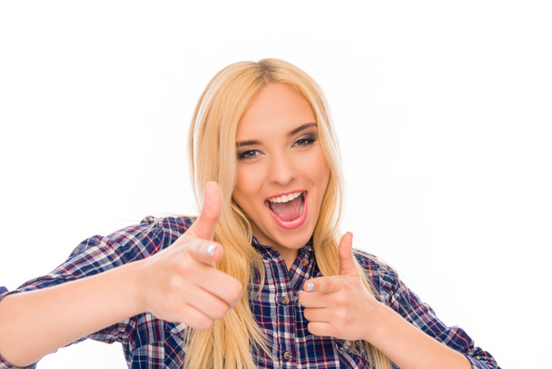 Cheerful happy girl smiling and pointing on camera - 写真・画像