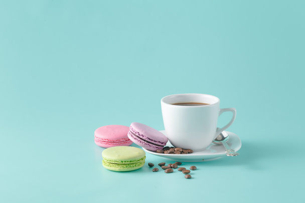 A cup of coffee on a saucer on a aquamarine background - Fotó, kép