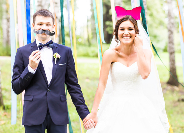 April Fools Day. Wedding couple posing with mask. - Photo, Image