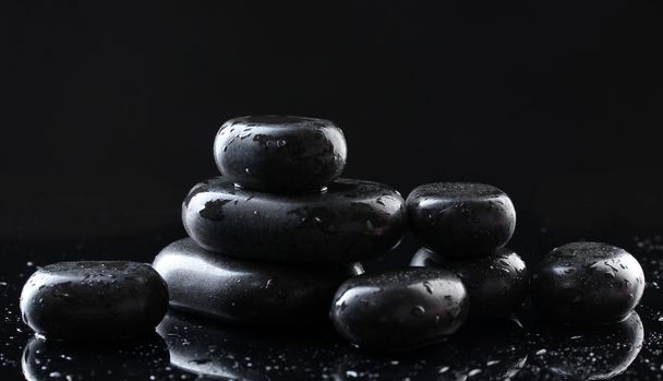 Spa stones with drops on black background - 写真・画像