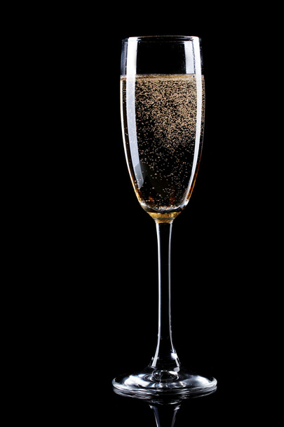 Glass of champagne on black background - Фото, изображение