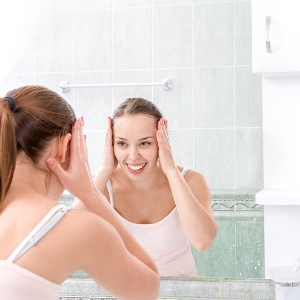 Young woman washing face - Foto, Imagen
