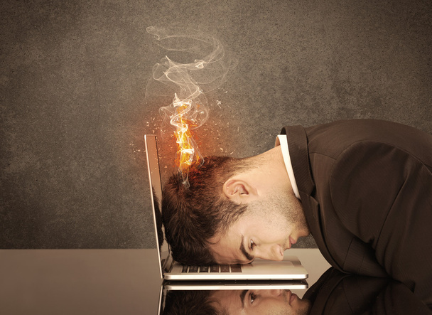 Sad business person's head catching fire - Фото, зображення