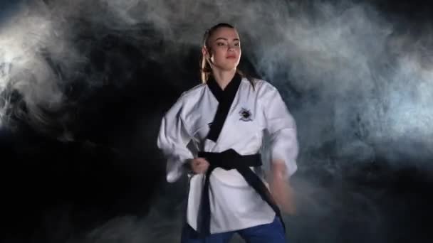 Karate kick girl in kimono practice technical shots. Black - Imágenes, Vídeo