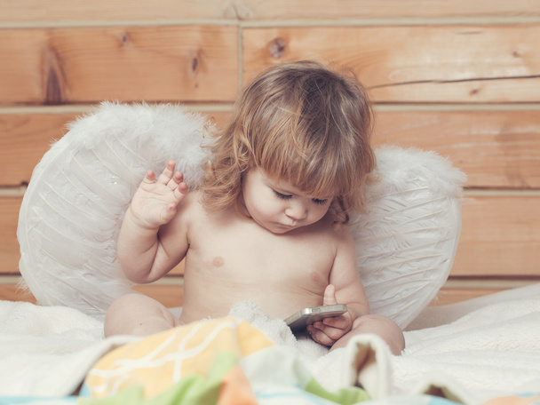 Angel boy with phone - Foto, afbeelding