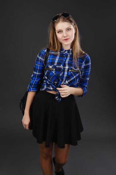 Portrait of a girl in a plaid shirt and black skirt - Photo, Image