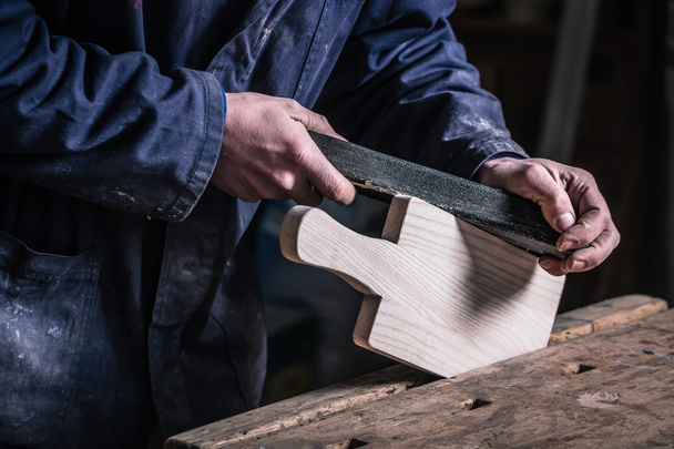 Timmerman schuren stuk hout met schuurpapier - Foto, afbeelding