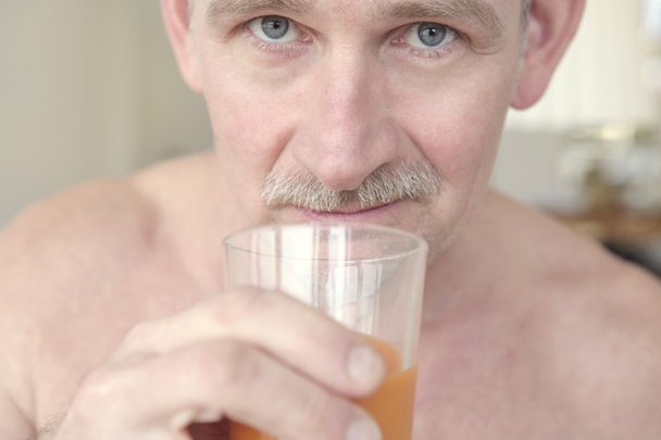close-up of mature man drinking juice - Фото, изображение