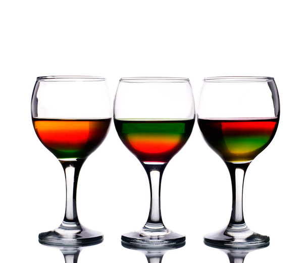 Wineglasses filled with multicolored cocktail - Photo, Image