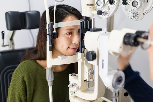 woman during an eye examination at clinic - Valokuva, kuva