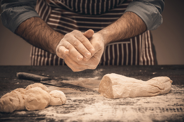 Male hands knead the dough. - Photo, Image