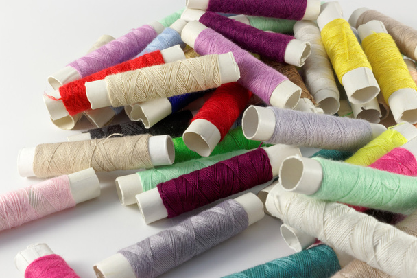 Multicolored bobbins of thread on white - Fotó, kép