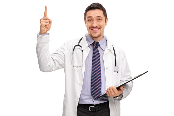 Doctor holding a clipboard and pointing up  - Foto, Imagen