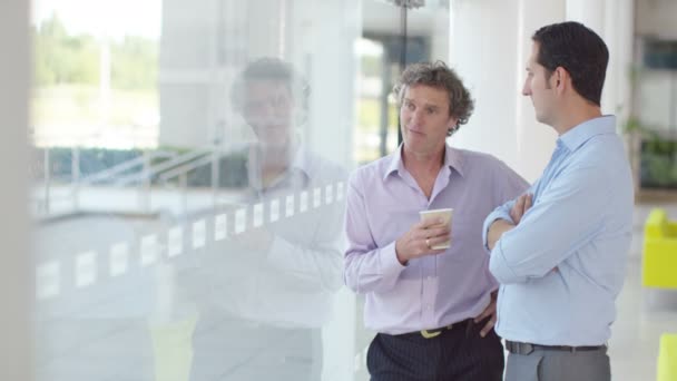 Businessmen in conversation at office - Materiaali, video