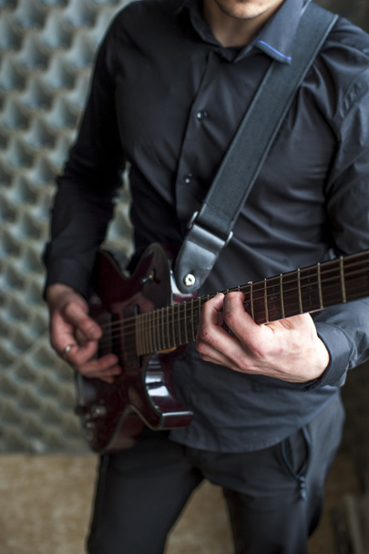 Male musician playing on electric guitar - 写真・画像