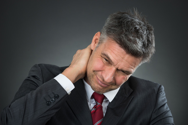 Businessman Suffering From Neck Pain - Фото, изображение
