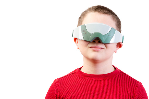 Content boy in red wears virtual reality glasses - Photo, image