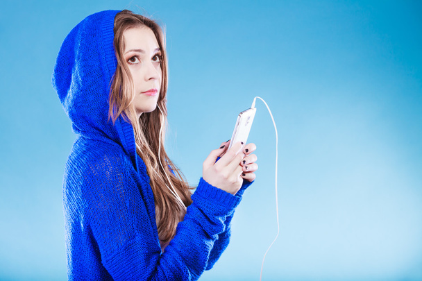 young woman with smart phone listening music - Photo, Image