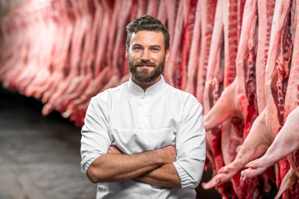 Portrait of a handsome butcher at the manufacturing - Фото, зображення