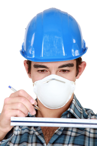 Young worker wearing protective face mask - Foto, immagini