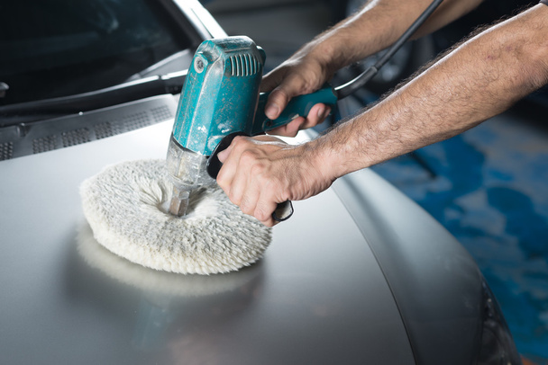 Car detailing series : Worker waxing grey car - Photo, Image