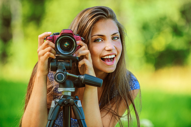 Gyönyörű nő fényképezett kamera állvány - Fotó, kép