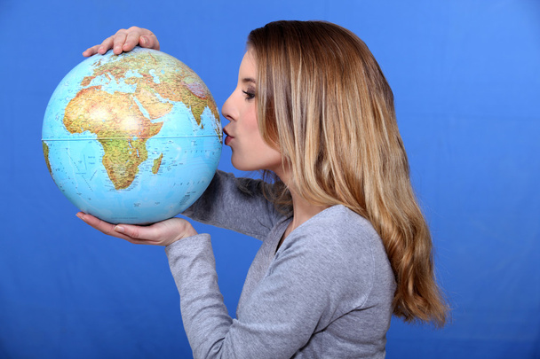 Woman kissing a globe - 写真・画像