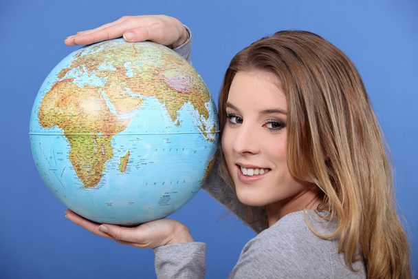 Attractive woman holding a globe - Foto, immagini