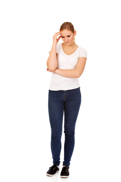 Worried young woman with folded arms - Photo, image