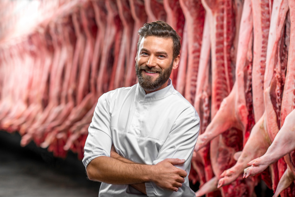 Portrait of a handsome butcher at the manufacturing - Fotó, kép