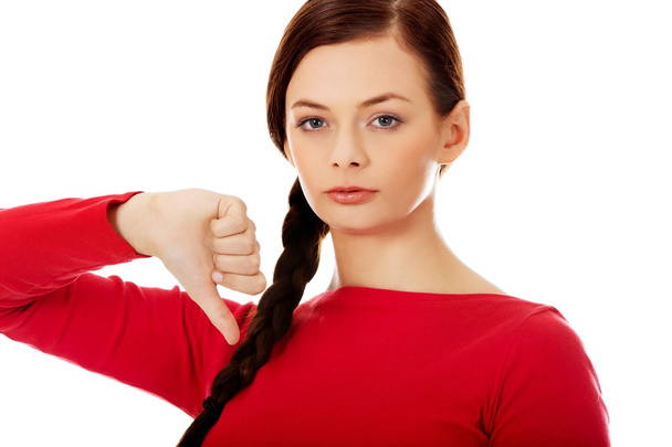 Young unhappy woman with thumb down - Photo, Image